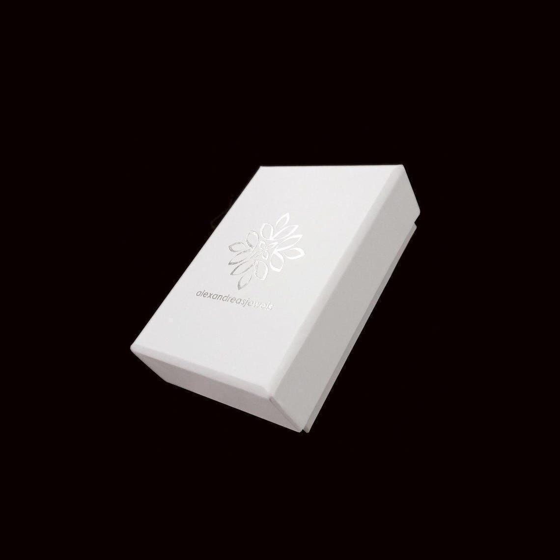 A white box with a silver flower design on it, set against a black background.