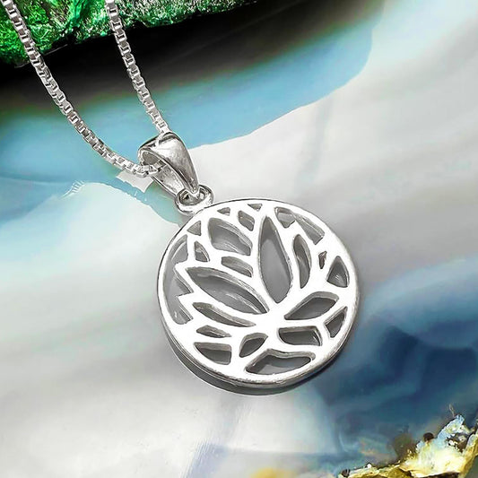 A silver pendant necklace with a circular pendant featuring a lotus flower design.