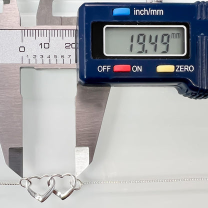 A digital caliper is measuring the length of a silver necklace chain, displaying the measurement as 19.49 millimeters.
