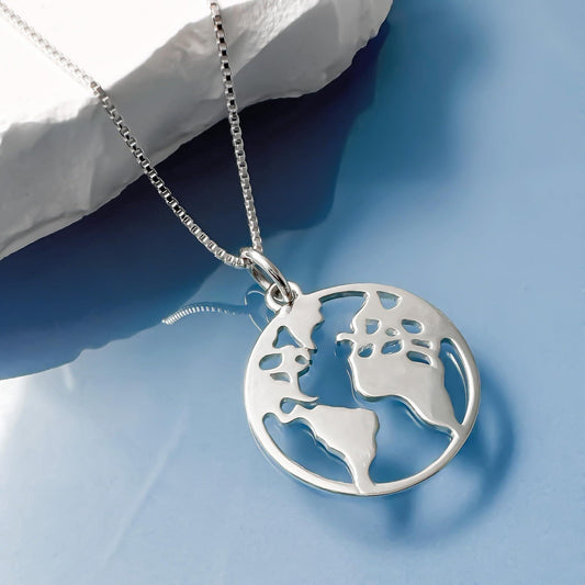 A silver necklace with a pendant in the shape of a world map.
