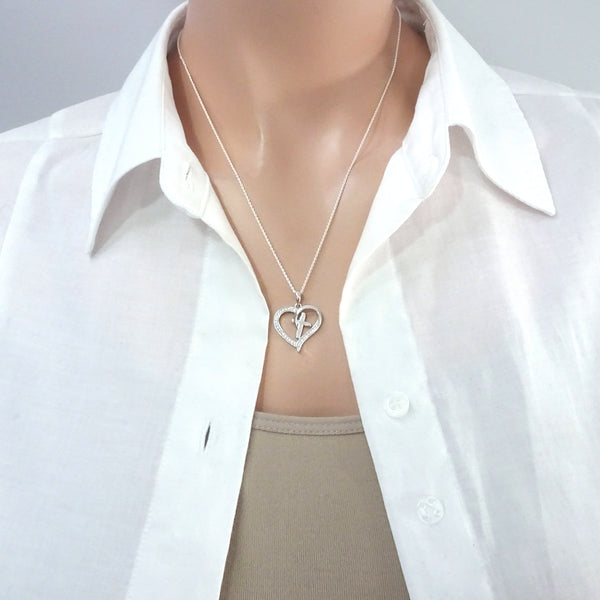 heart and cross necklace on a model mannequin