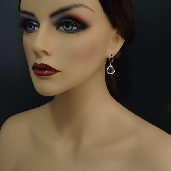 amethyst purple framed glass earrings on a model mannequin
