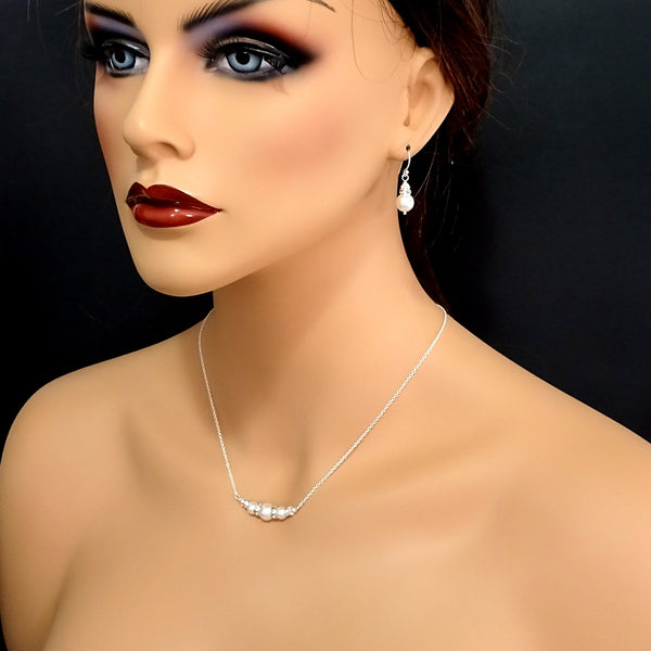 ivory pearl and clear crystal necklace and earrings set on a model mannequin