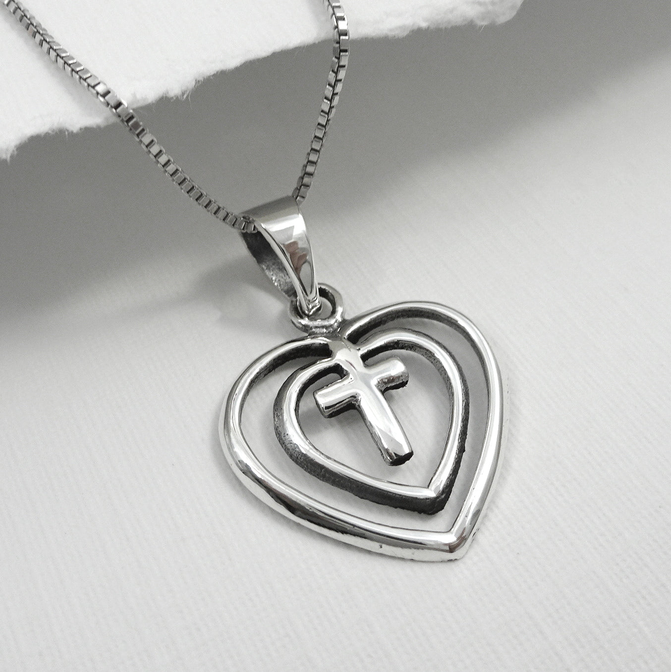 cross enclosed in double heart pendant with chain