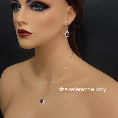 dark purple framed glass necklace and earrings on a model mannequin