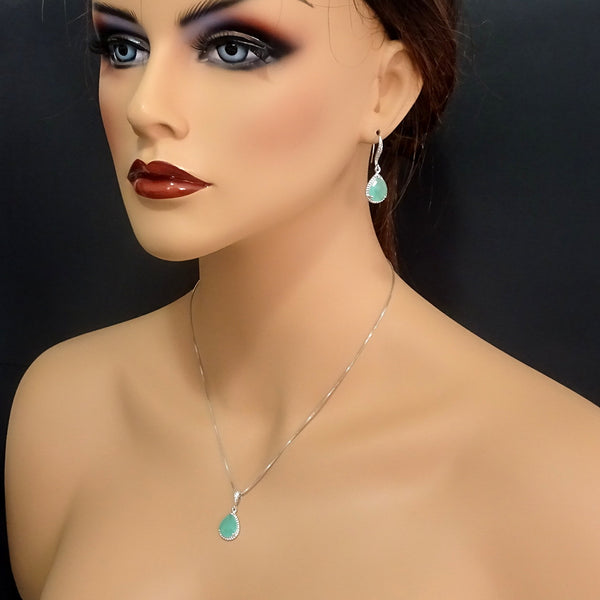 mint green framed glass necklace and earrings on a model mannequin
