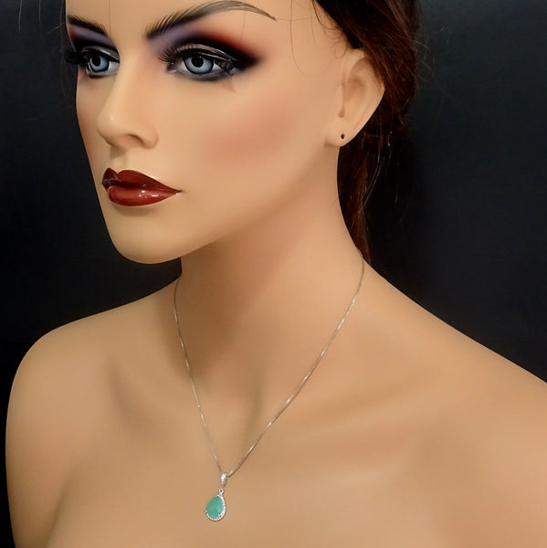 mint green framed glass necklace on a model mannequin