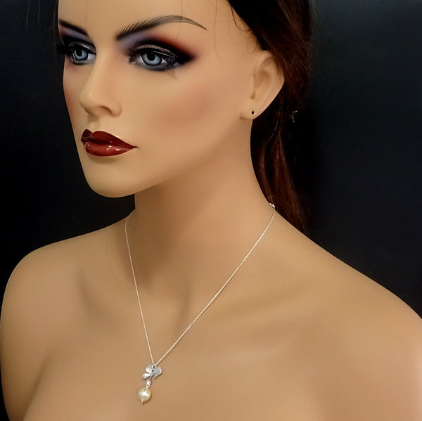 orchid and pearl necklace and earrings set on a model mannequin