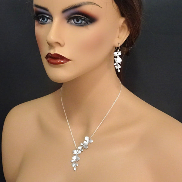 orchid necklace and earrings set on a model mannequin