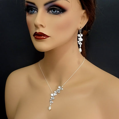 triple orchid cascade and pearl necklace and earrings set on a model mannequin