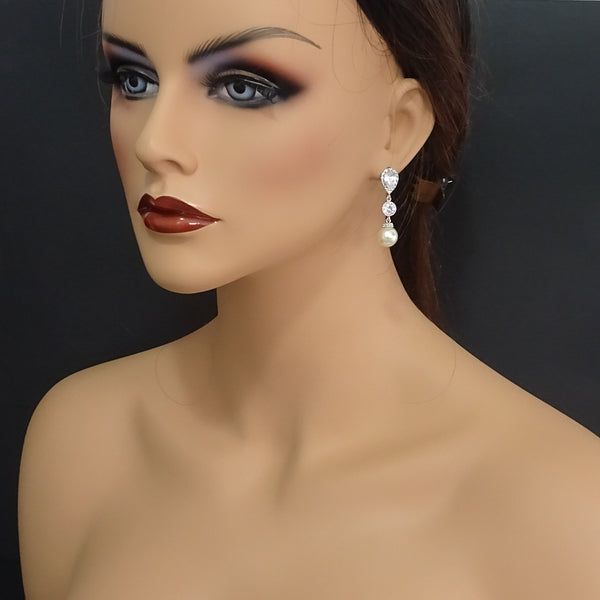 ivory pearl dangle earrings on a model mannequin