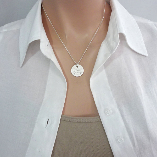 engraved disc necklace on a model mannequin
