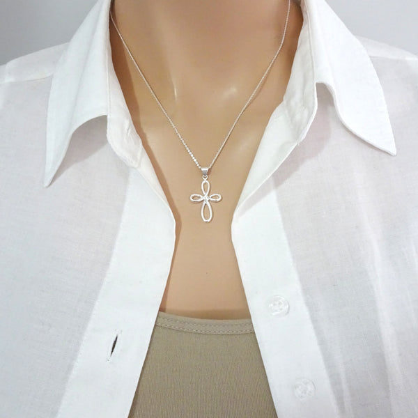 infinity cross necklace on a model mannequin