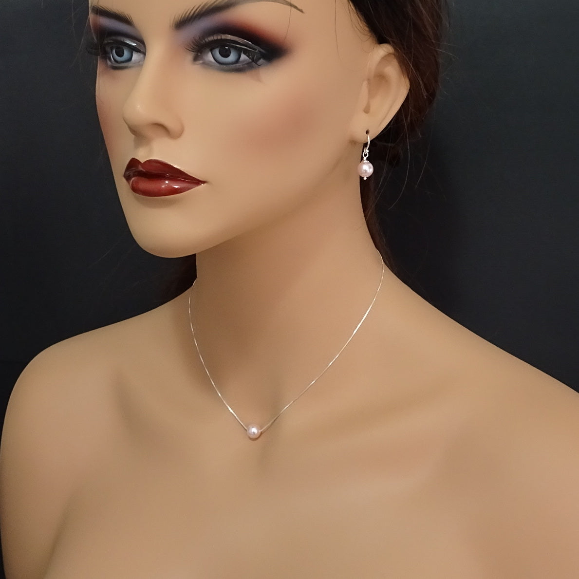 floating pearl necklace and earrings on a model mannequin