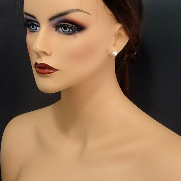 ivory pearl stud earrings on a model mannequin