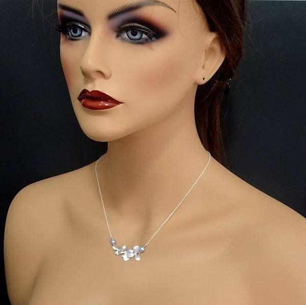 orchid and pearl necklace on a model mannequin