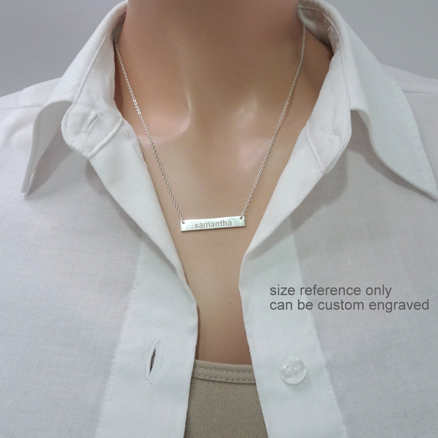 engraved name bar necklace on a model mannequin