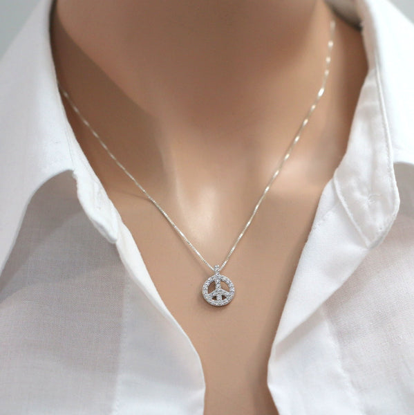 cubic zirconia peace sign necklace on a model mannequin
