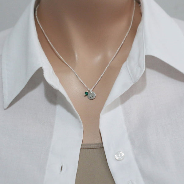 stamped disc with emerald green crystal necklace on a model mannequin