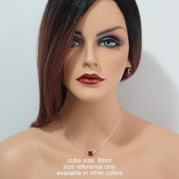 fuschia cube necklace and earrings on a model mannequin