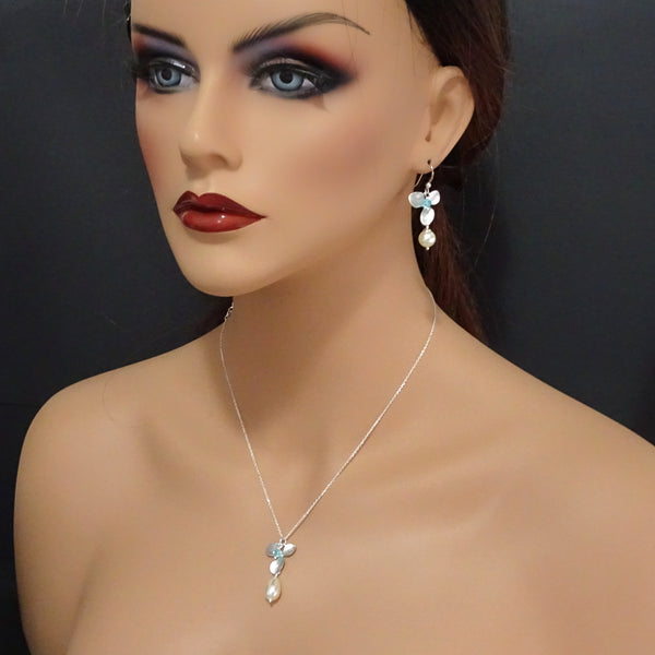 orchid, pearl and crystal earrings on a model